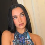 Dua Lipa Stuns in Avant-Garde Halter Top Crafted from Hundreds of Buttons and High-End Luxury Timepiece